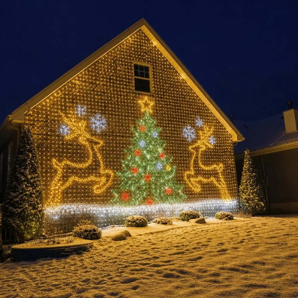 Christmas tree and reindeer LED design on a house gable